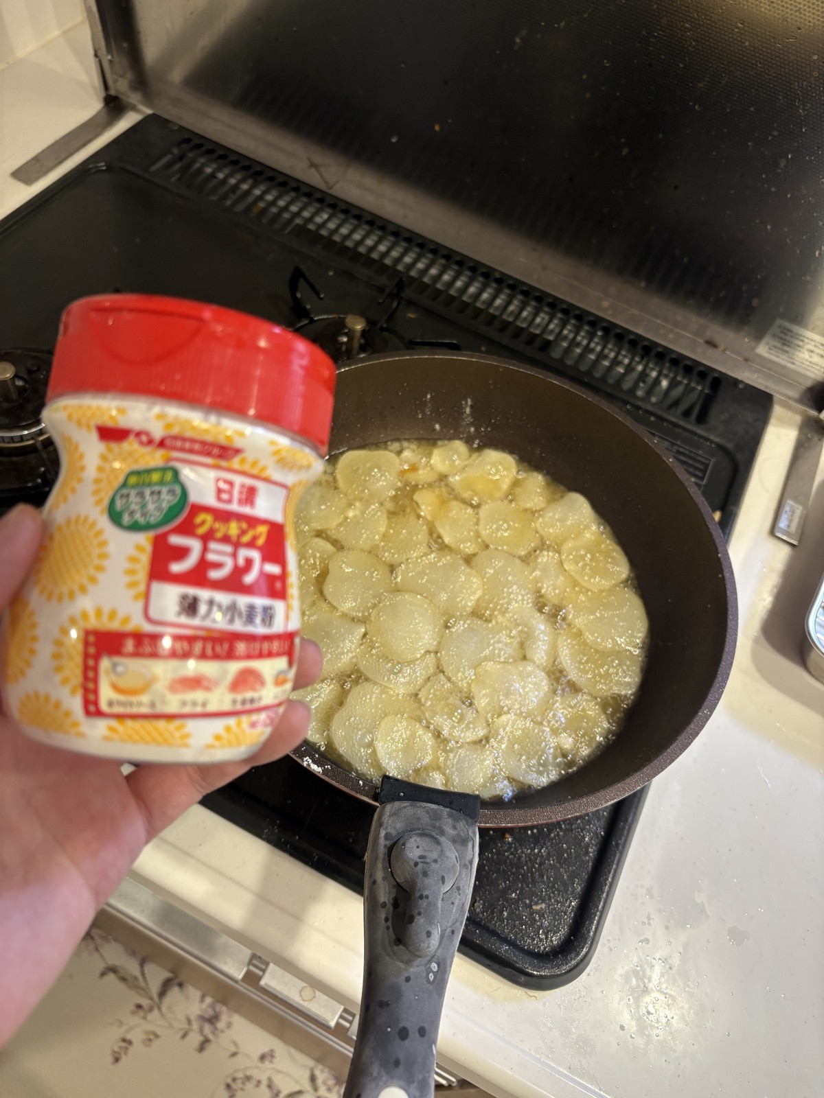 フライパンで揚げている最中のポテチとフラワー粉